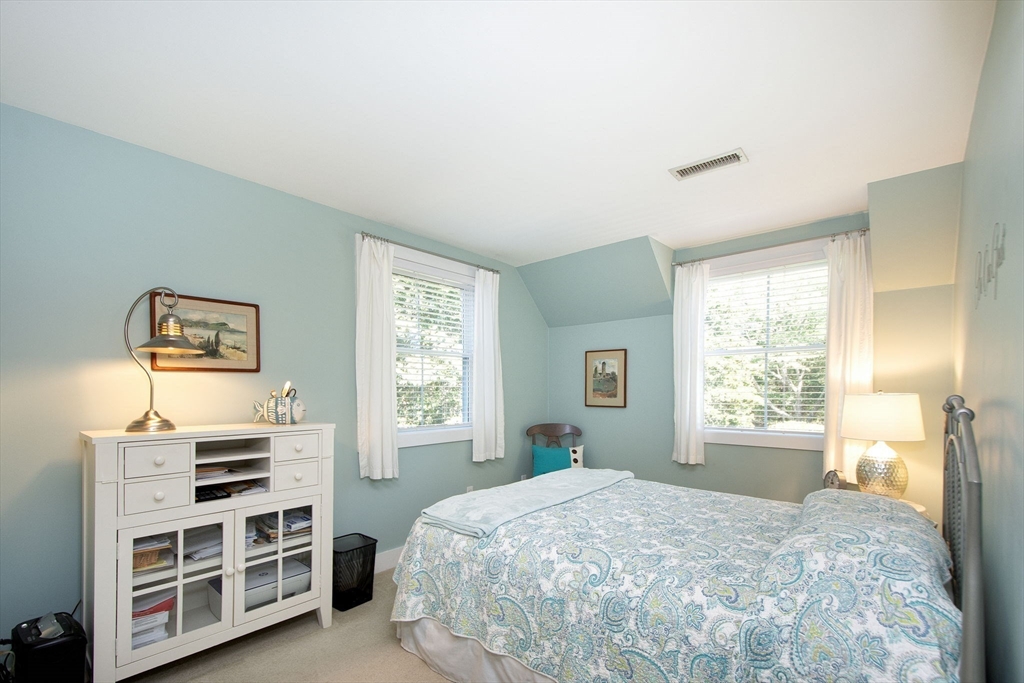 1 Gatehouse Lane, Unit 1 Hull, MA 02045 - Photo 30 of 42 a bedroom with a bed next to a window