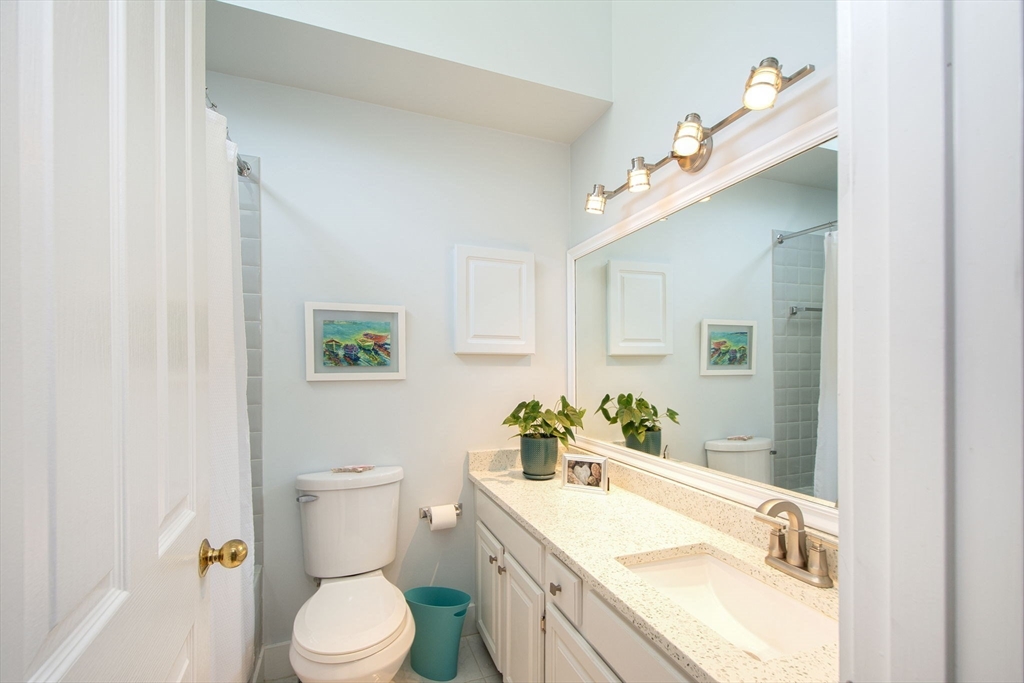1 Gatehouse Lane, Unit 1 Hull, MA 02045 - Photo 31 of 42 a bathroom with a granite countertop sink mirror vanity and toilet
