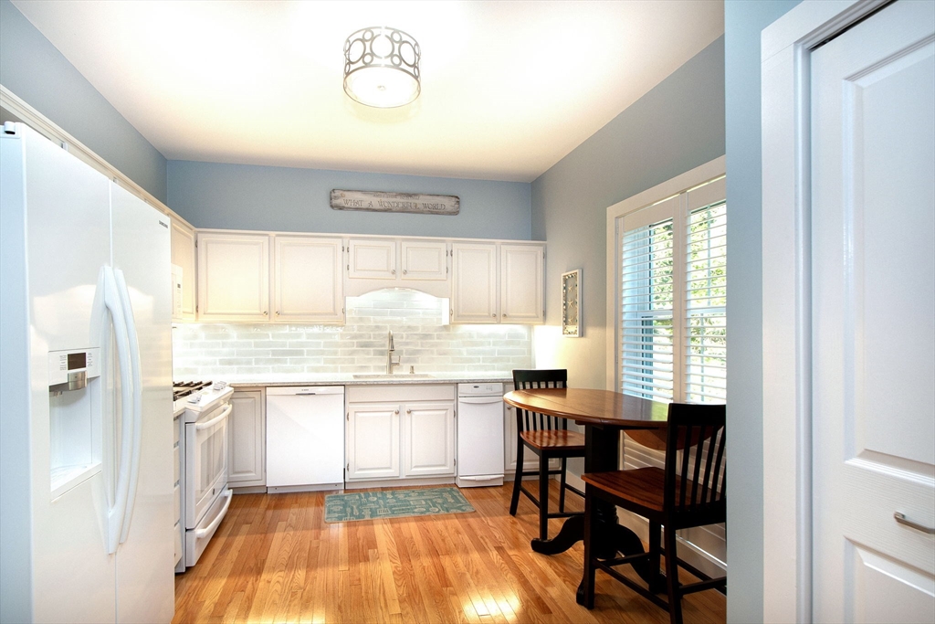 1 Gatehouse Lane, Unit 1 Hull, MA 02045 - Photo 5 of 42 a kitchen with a sink cabinets and dining table chair