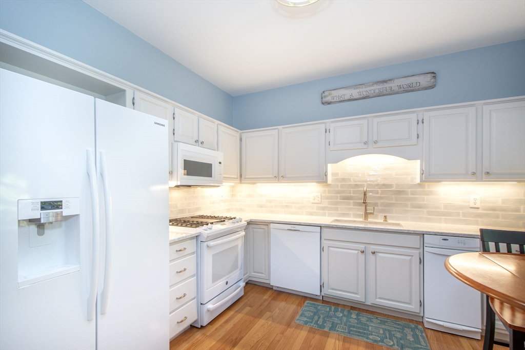 1 Gatehouse Lane, Unit 1 Hull, MA 02045 - Photo 6 of 42 a kitchen with a sink white cabinets and stainless steel appliances