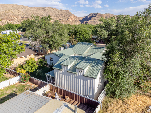 236 West 300 South Hurricane, UT 84737 - Photo 76 of 76 Property featuring a green metal roof, white vertical siding, and a screened porch