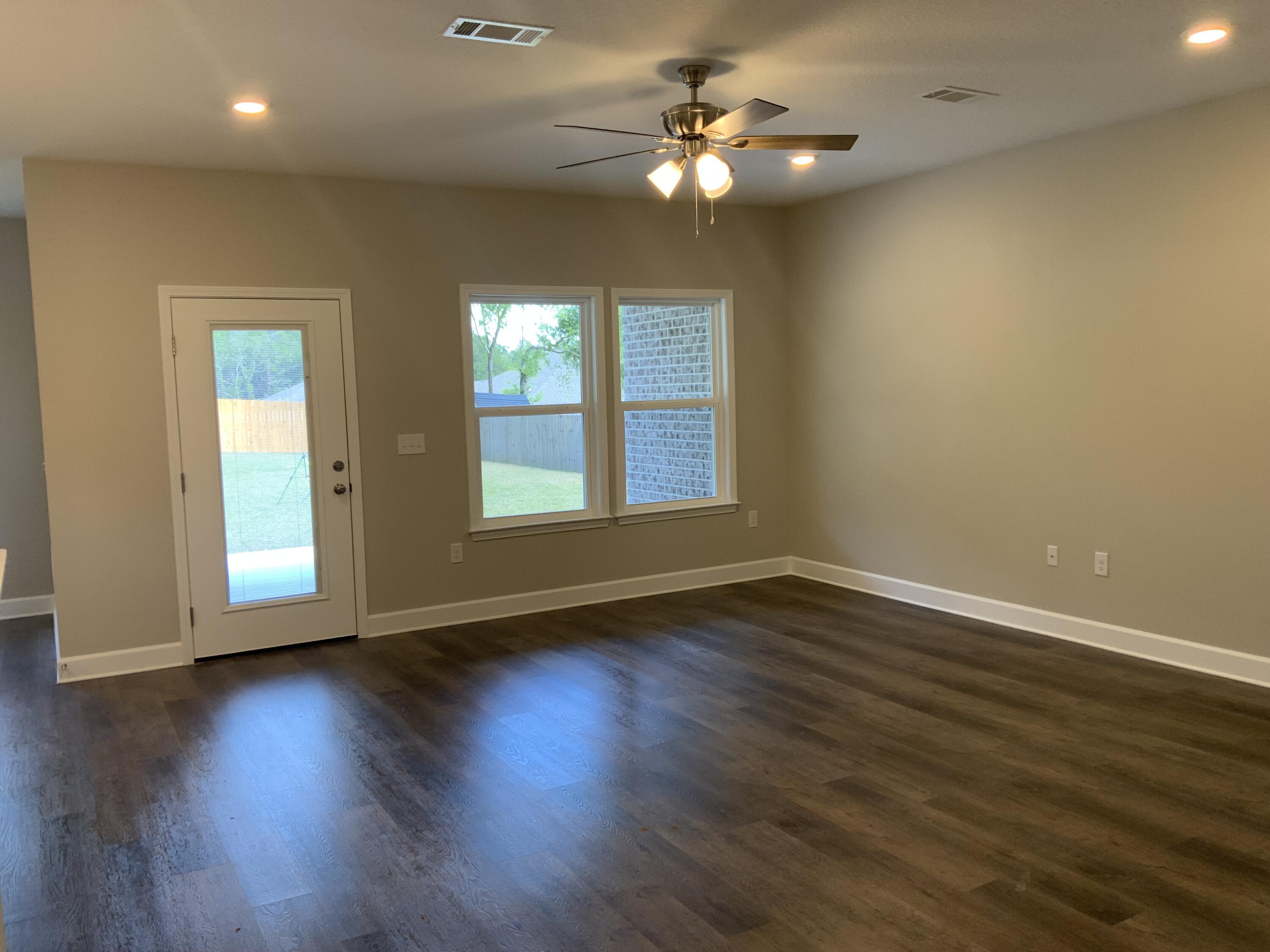 5179 Rabbit Run Crestview, FL 32539 - Photo 3 of 18 a view of an empty room with wooden floor and a window