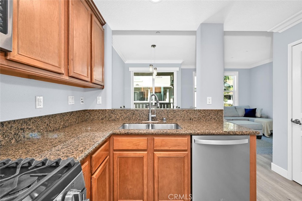 22 Valmont Way Ladera Ranch, CA 92694 - Photo 11 of 47 a kitchen with granite countertop a sink and a stove