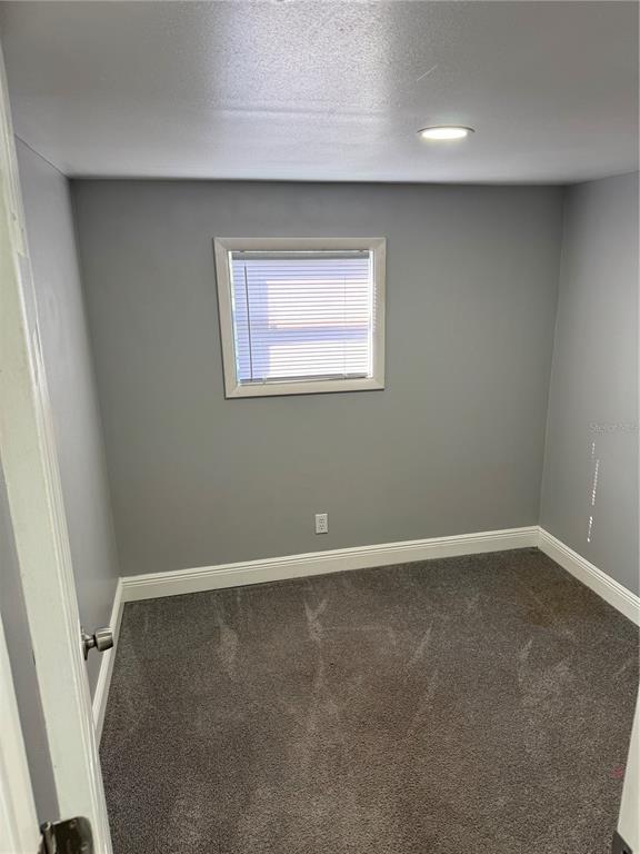 9633 Norm Street Hudson, FL 34669 - Photo 11 of 15 an empty room with a workbench