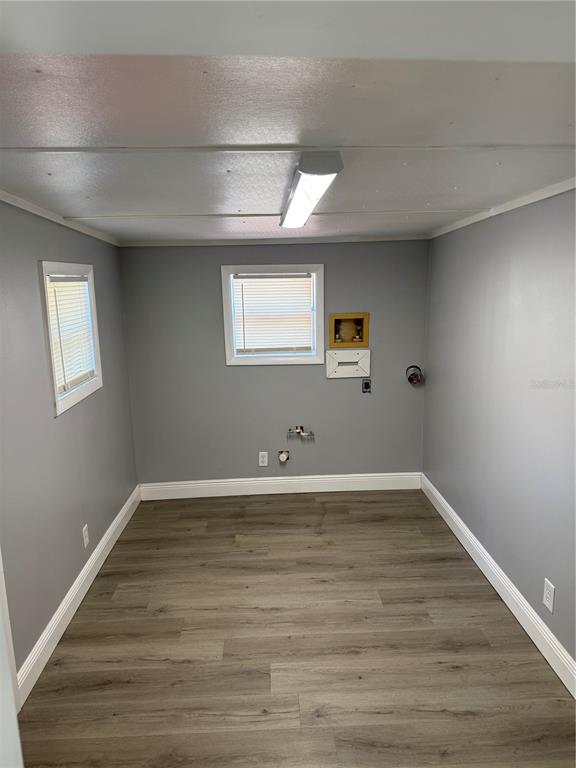 9633 Norm Street Hudson, FL 34669 - Photo 12 of 15 a view of an empty room with wooden floor and a window