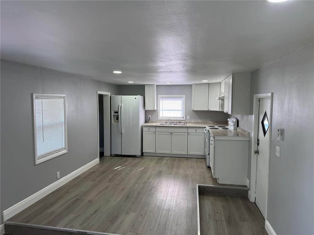 9633 Norm Street Hudson, FL 34669 - Photo 4 of 15 a kitchen with stainless steel appliances granite countertop a refrigerator sink and cabinets