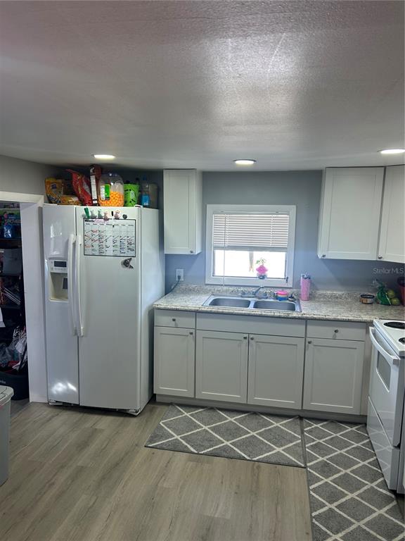 9633 Norm Street Hudson, FL 34669 - Photo 5 of 15 a kitchen with granite countertop a refrigerator and a sink