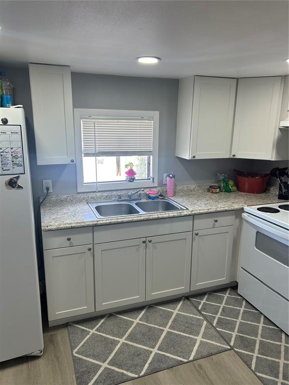 9633 Norm Street Hudson, FL 34669 - Photo 6 of 15 a kitchen with a sink window and cabinets