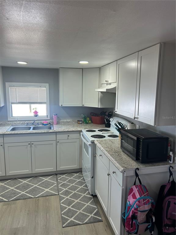 9633 Norm Street Hudson, FL 34669 - Photo 7 of 15 a kitchen with granite countertop cabinets stainless steel appliances and a sink