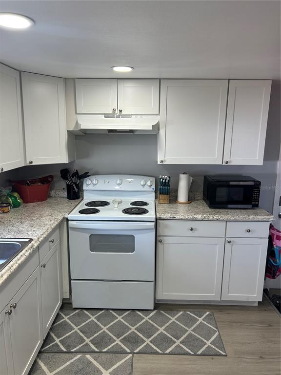 9633 Norm Street Hudson, FL 34669 - Photo 8 of 15 a kitchen with a stove and a cabinets