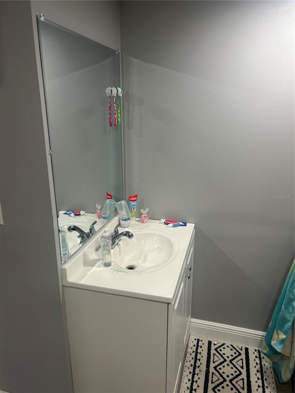 9633 Norm Street Hudson, FL 34669 - Photo 9 of 15 a bathroom with a sink and a mirror