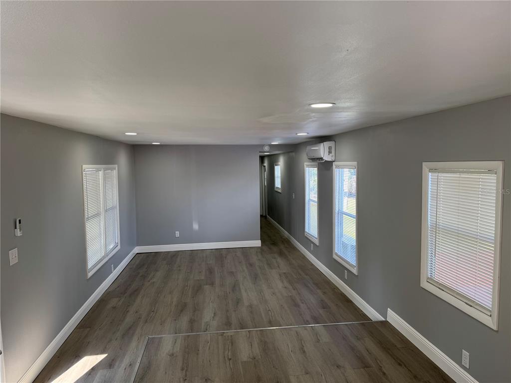 9633 Norm Street Hudson, FL 34669 - Photo 10 of 15 wooden floor in an empty room with a window