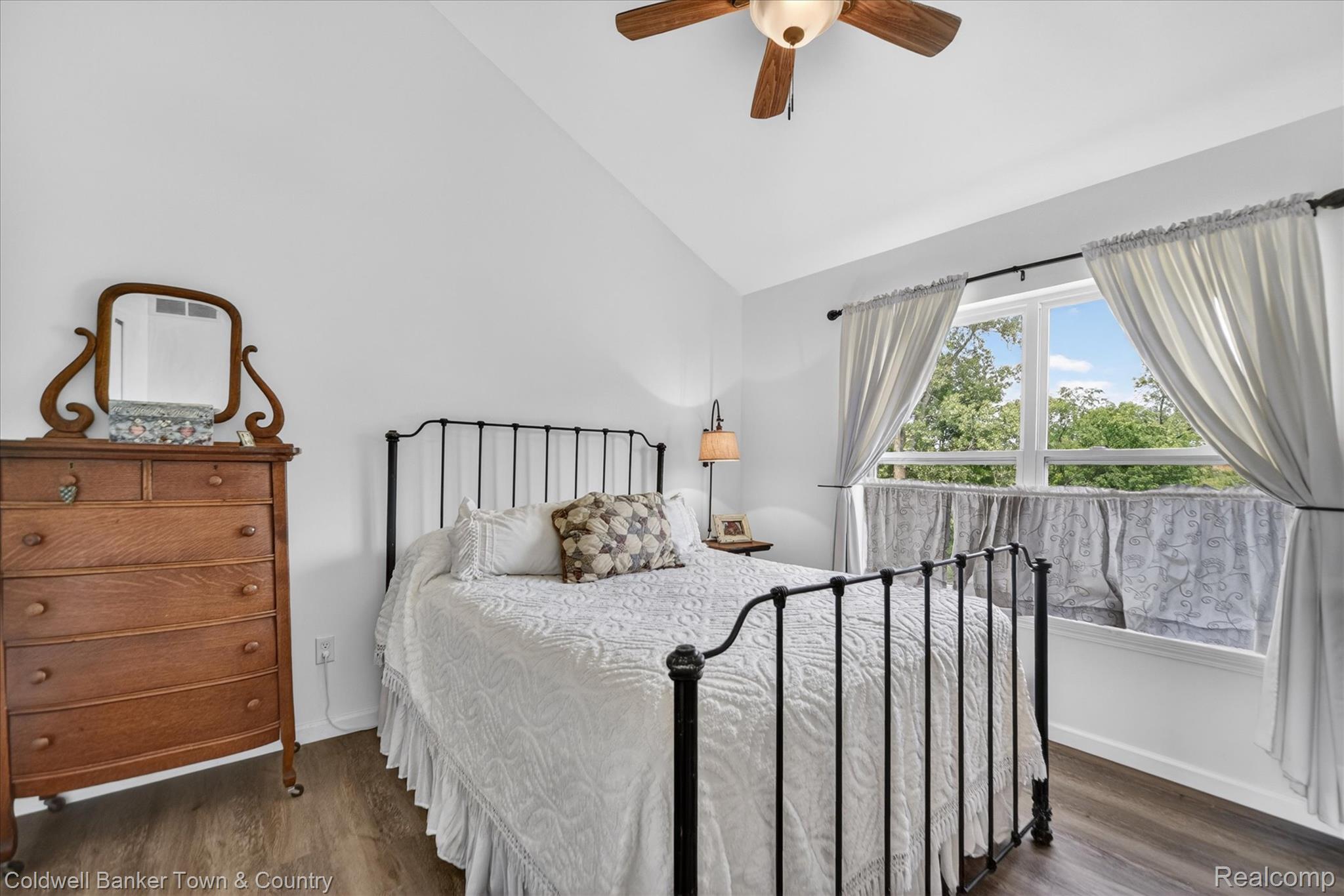 918 Gray Fox Court Howell, MI 48843 - Photo 55 of 84 Vaulted ceiling bedroom featuring wood-finish flooring, a ceiling fan with integrated lighting, and a large window with natural light