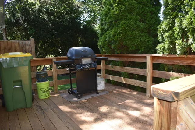 a view of a chairs and table in the back yard