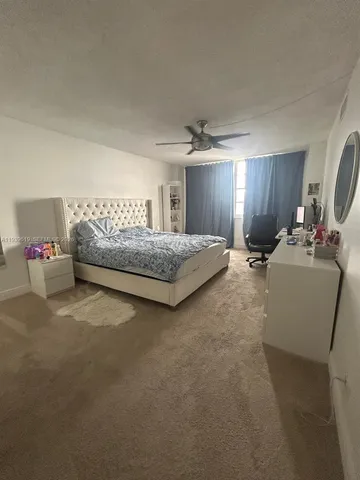 a bedroom with bed and window