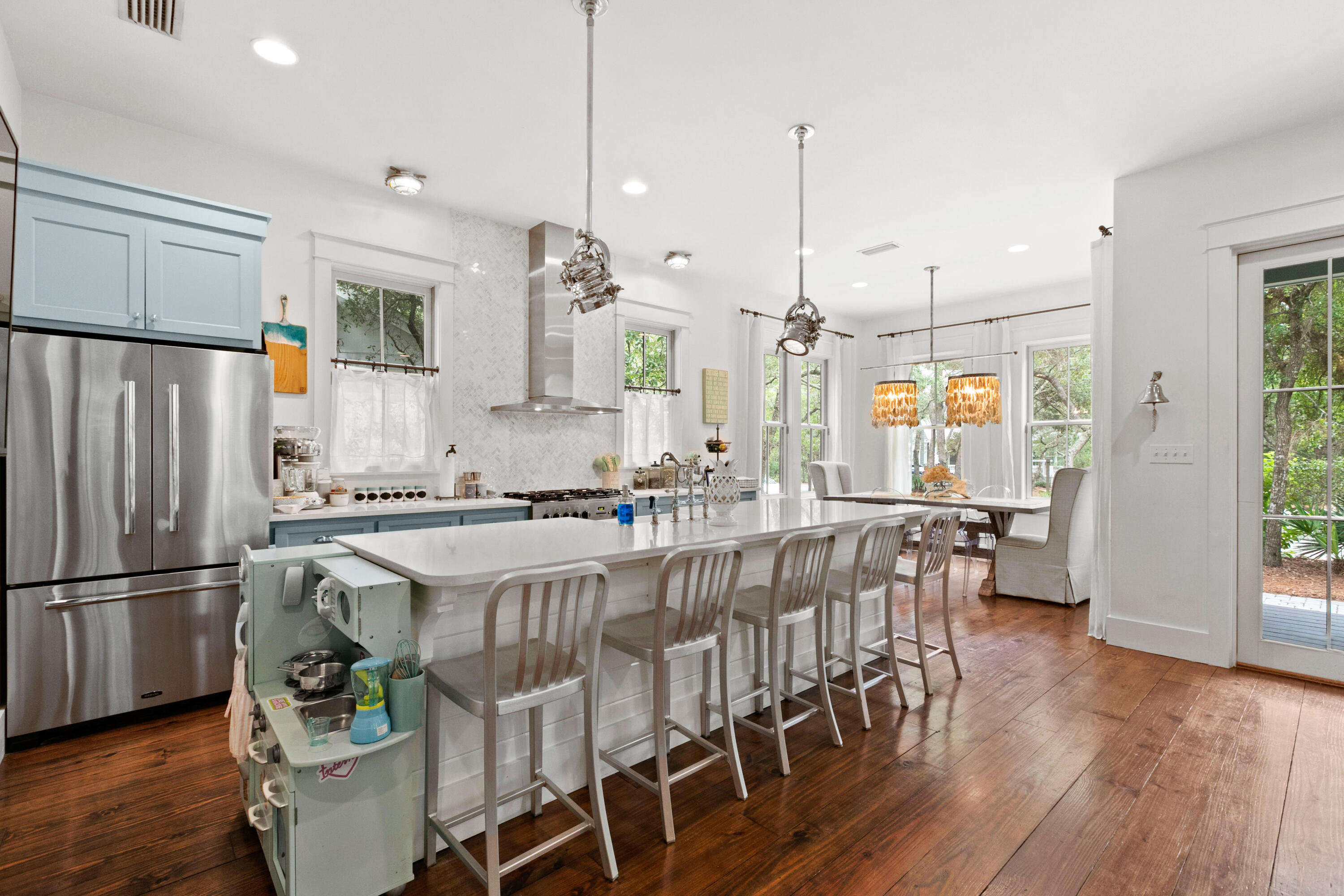 120 Hammock Lane Santa Rosa Beach, FL 32459 - Photo 17 of 57 a kitchen with stainless steel appliances granite countertop a refrigerator a sink dishwasher a dining table and chairs with wooden floor