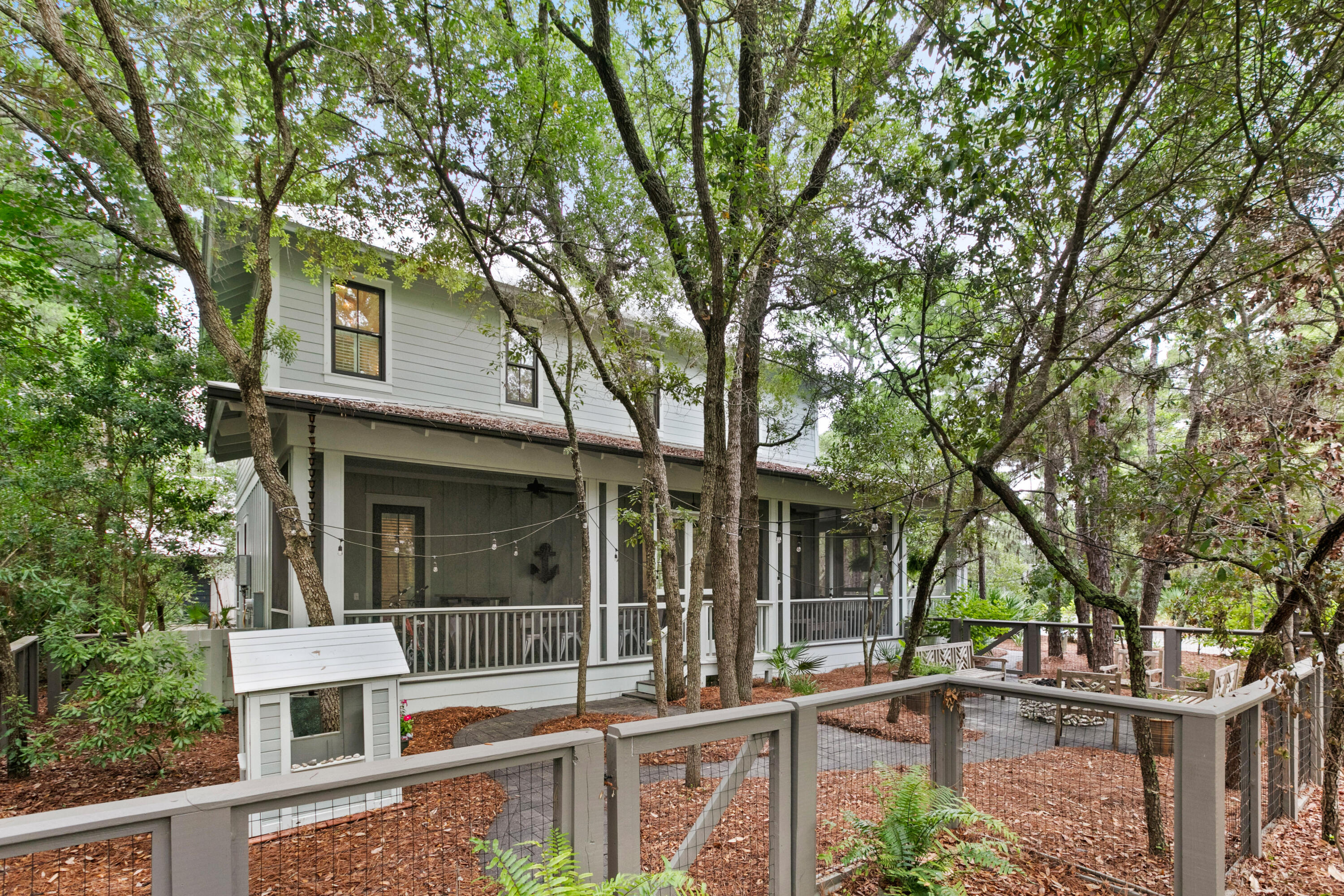 120 Hammock Lane Santa Rosa Beach, FL 32459 - Photo 5 of 57 a front view of a house with a garden