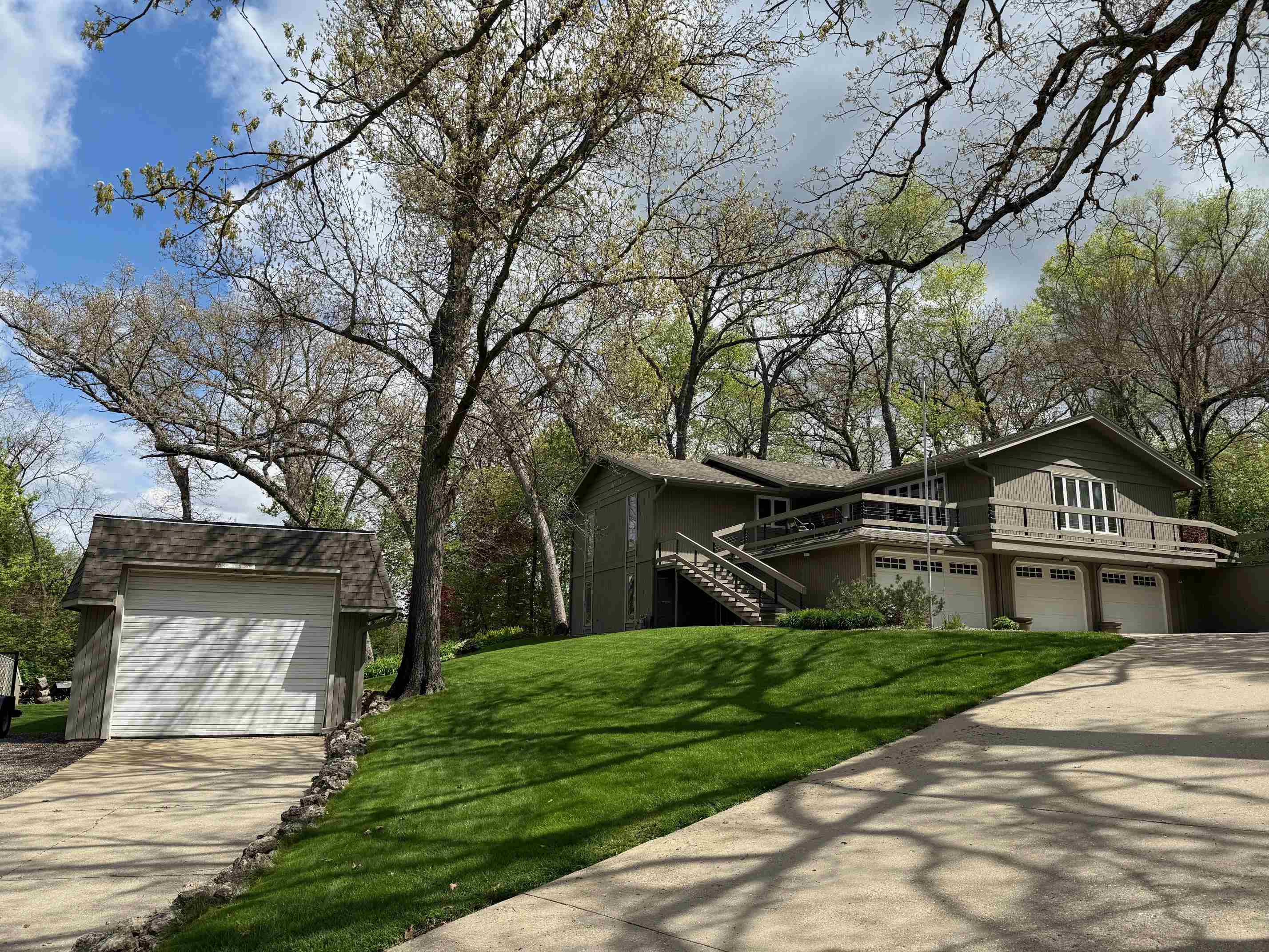 7758 Ray Court Roscoe, IL 61073 - Photo 1 of 37 a front view of a house with a garden and trees