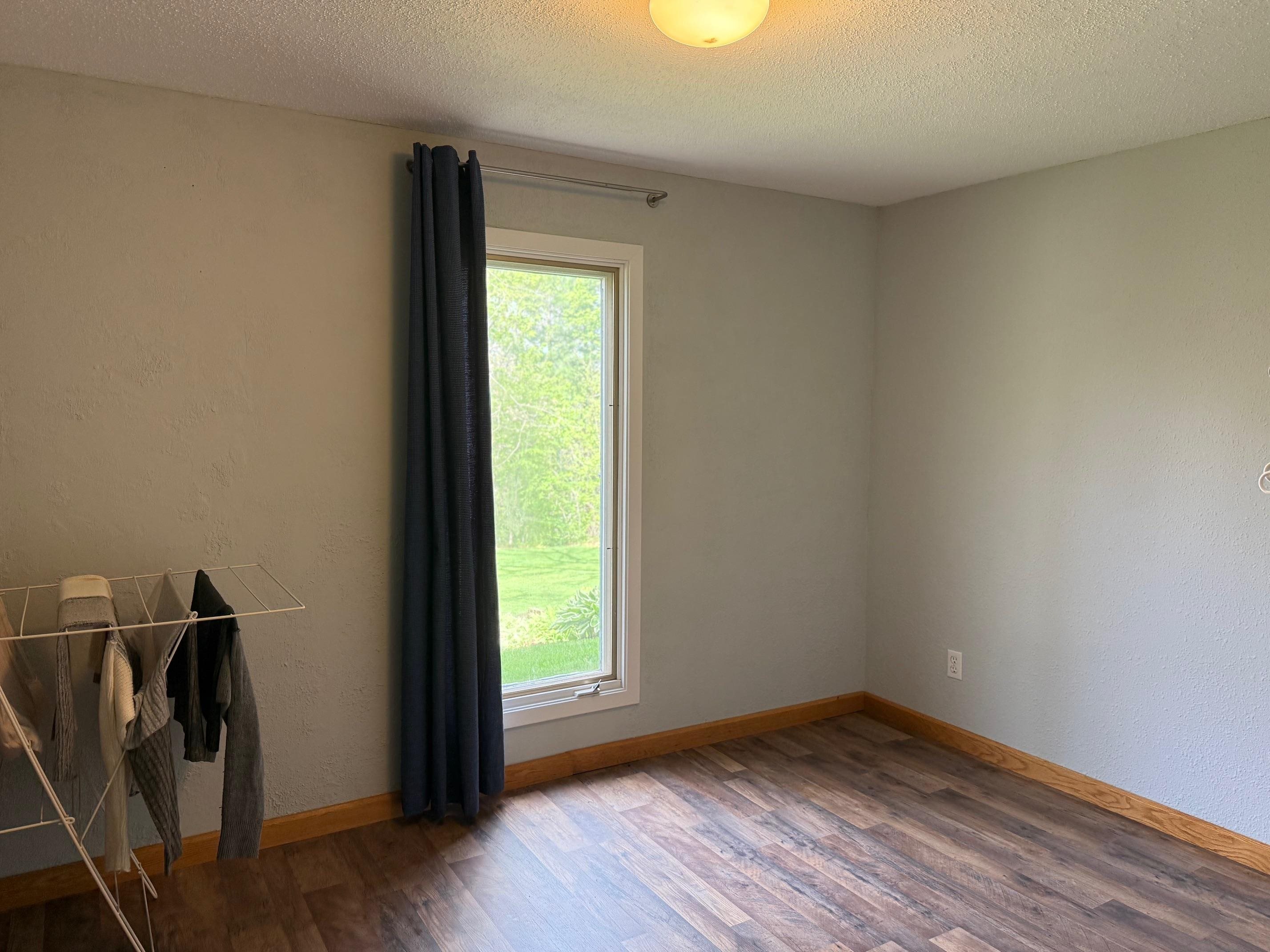 7758 Ray Court Roscoe, IL 61073 - Photo 23 of 37 a view of an empty room with wooden floor and a window