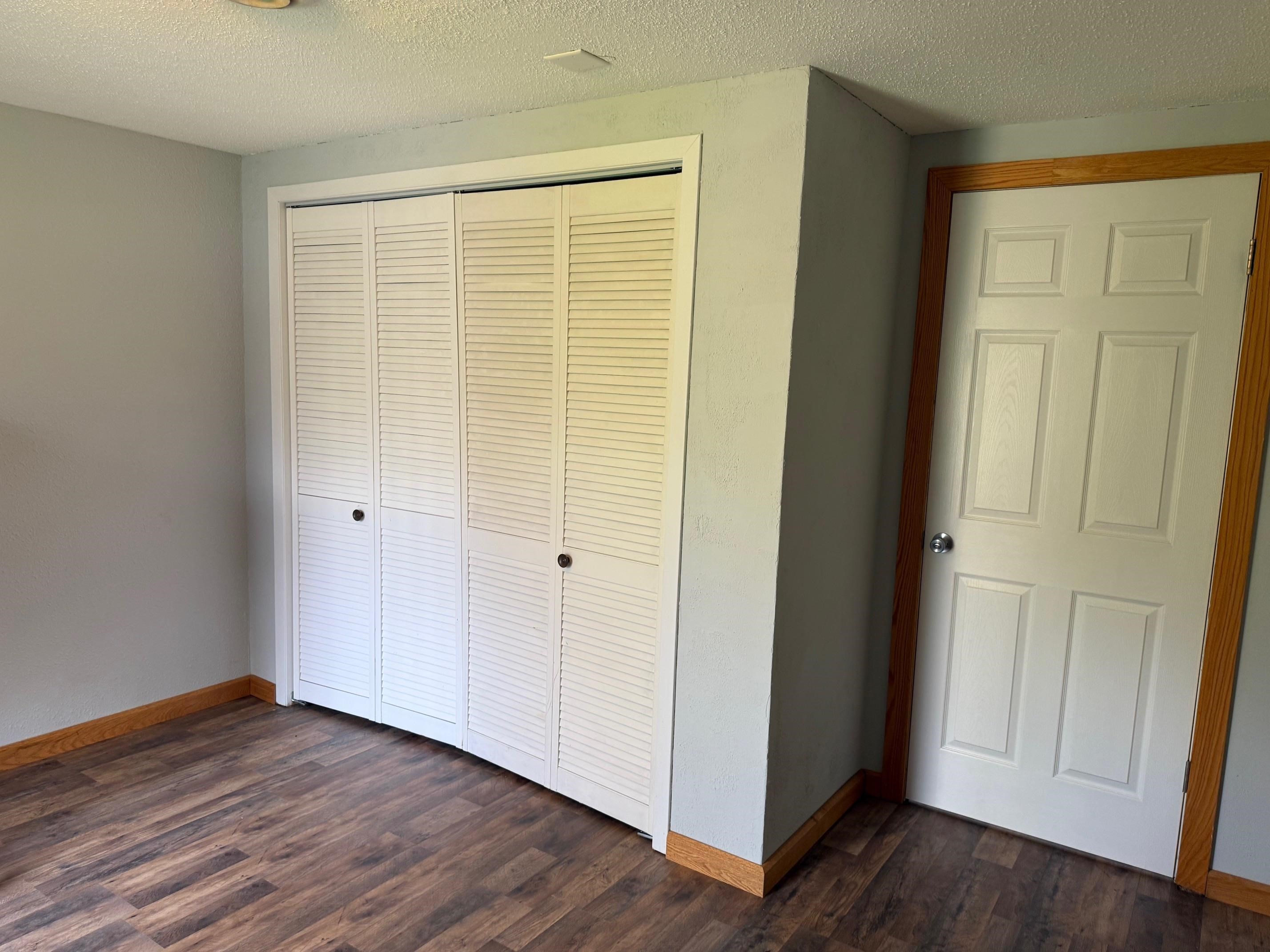 7758 Ray Court Roscoe, IL 61073 - Photo 24 of 37 a view of an empty room with wooden floor and closet