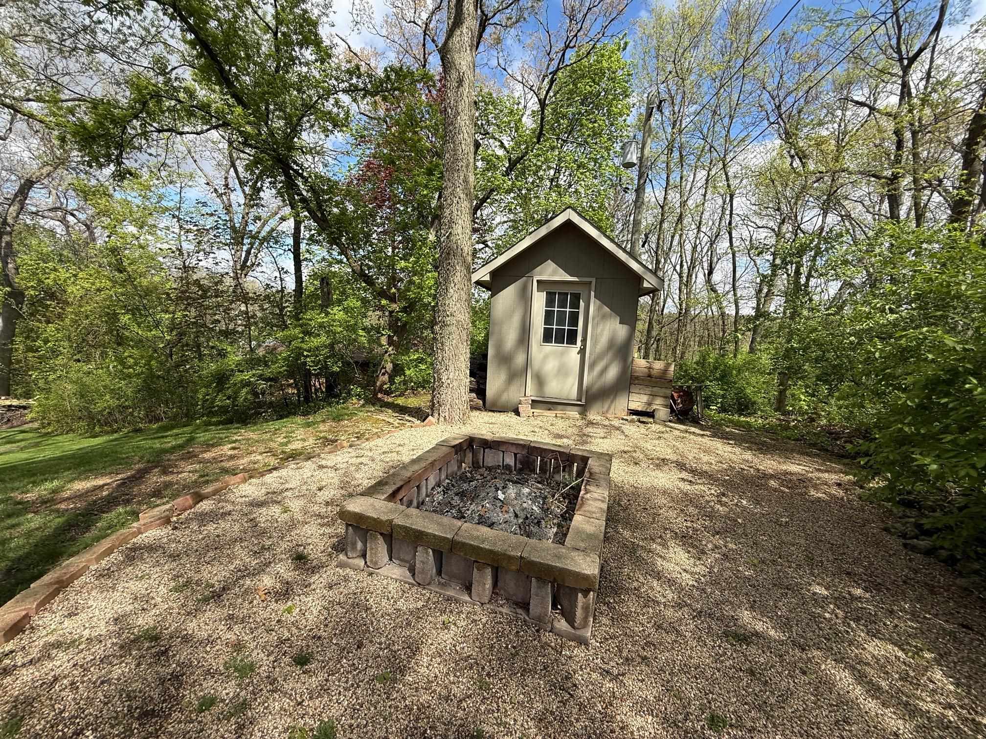 7758 Ray Court Roscoe, IL 61073 - Photo 34 of 37 a view of a wooden house with a yard and large trees