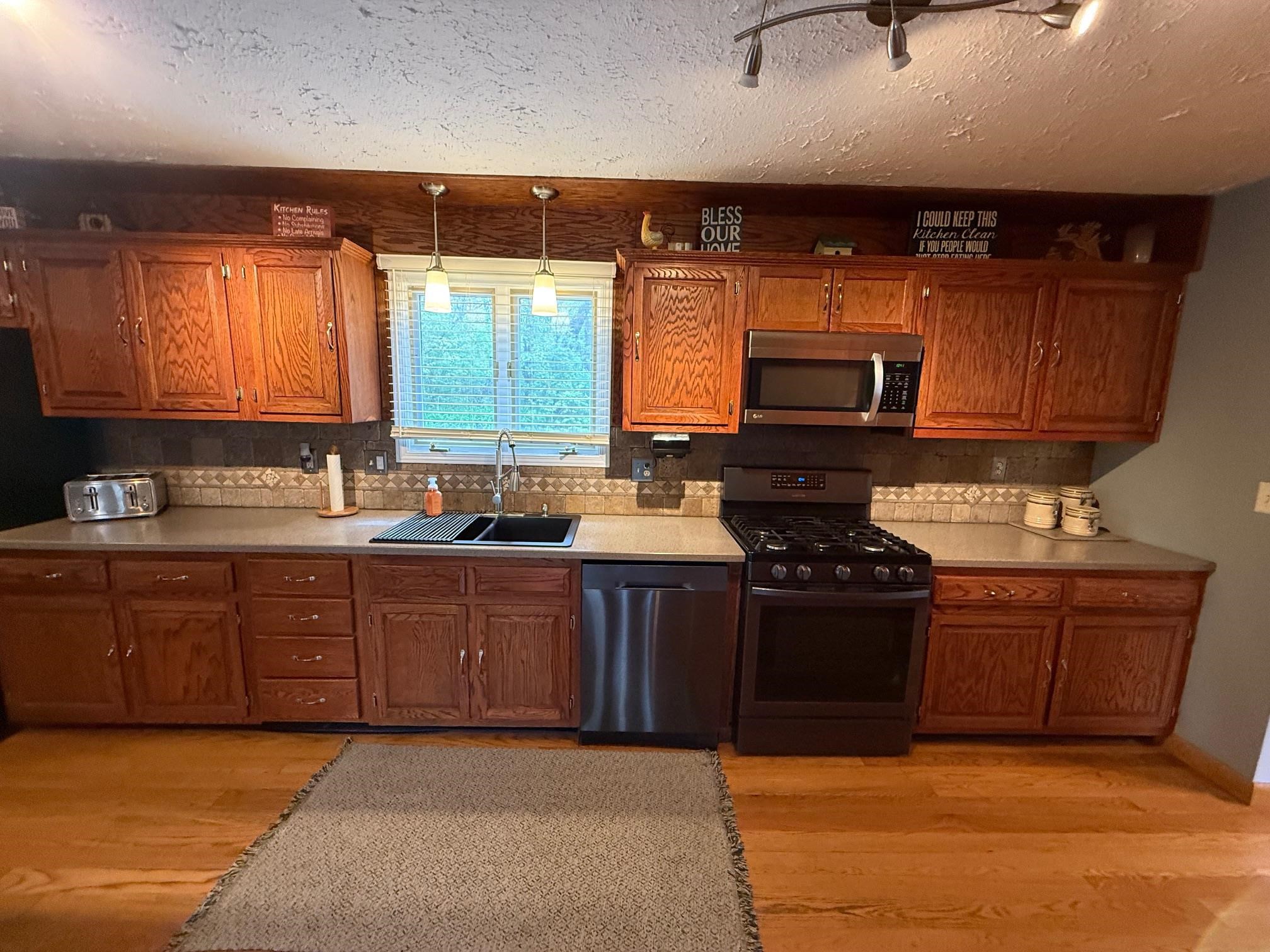 7758 Ray Court Roscoe, IL 61073 - Photo 7 of 37 a kitchen with stainless steel appliances granite countertop a stove sink and cabinets