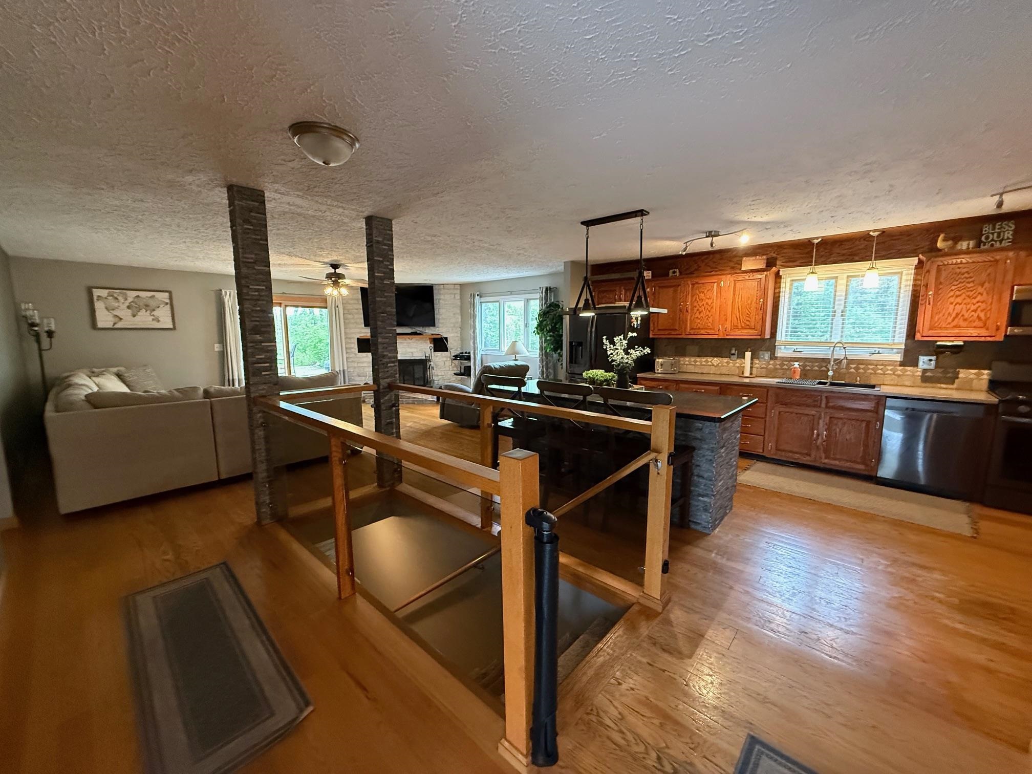 7758 Ray Court Roscoe, IL 61073 - Photo 8 of 37 a kitchen with stainless steel appliances granite countertop a sink and a refrigerator