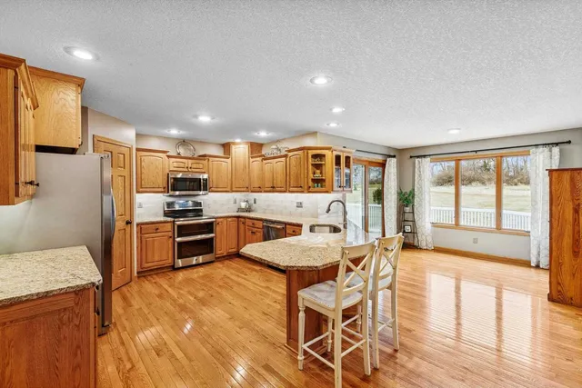 a large kitchen with a table and chairs