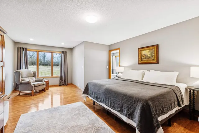 a spacious bedroom with a large bed and a couch