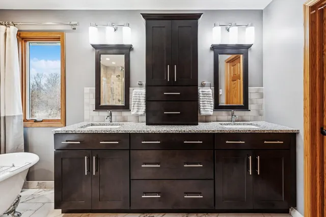 a bathroom with a granite countertop sink a toilet and a mirror