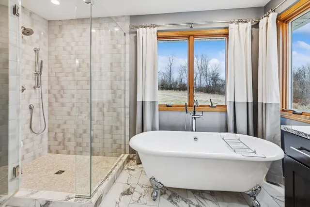 a bathroom with a granite countertop sink and a shower