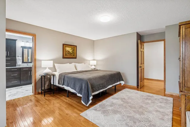 a bedroom with a bed and a lamp