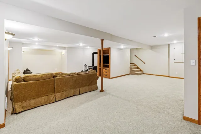 a living room with furniture and a gym machine