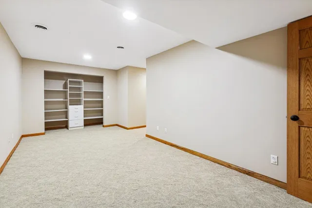 an empty room with a closet and cabinet
