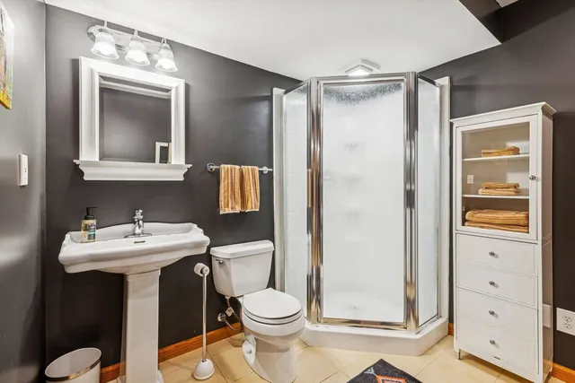 a bathroom with a sink mirror toilet and shower