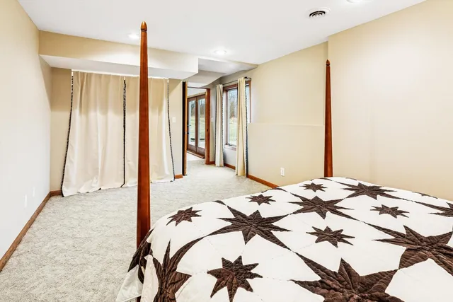 a bedroom with a bed and a chandelier