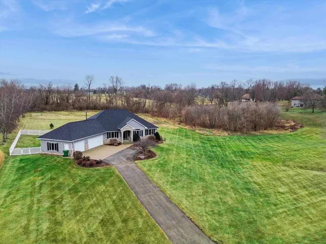 a house with green field in front of it