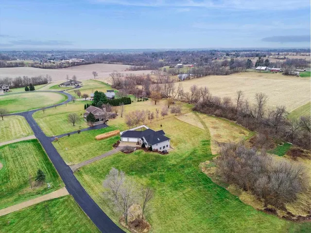 an aerial view of residential houses with outdoor space and lake view
