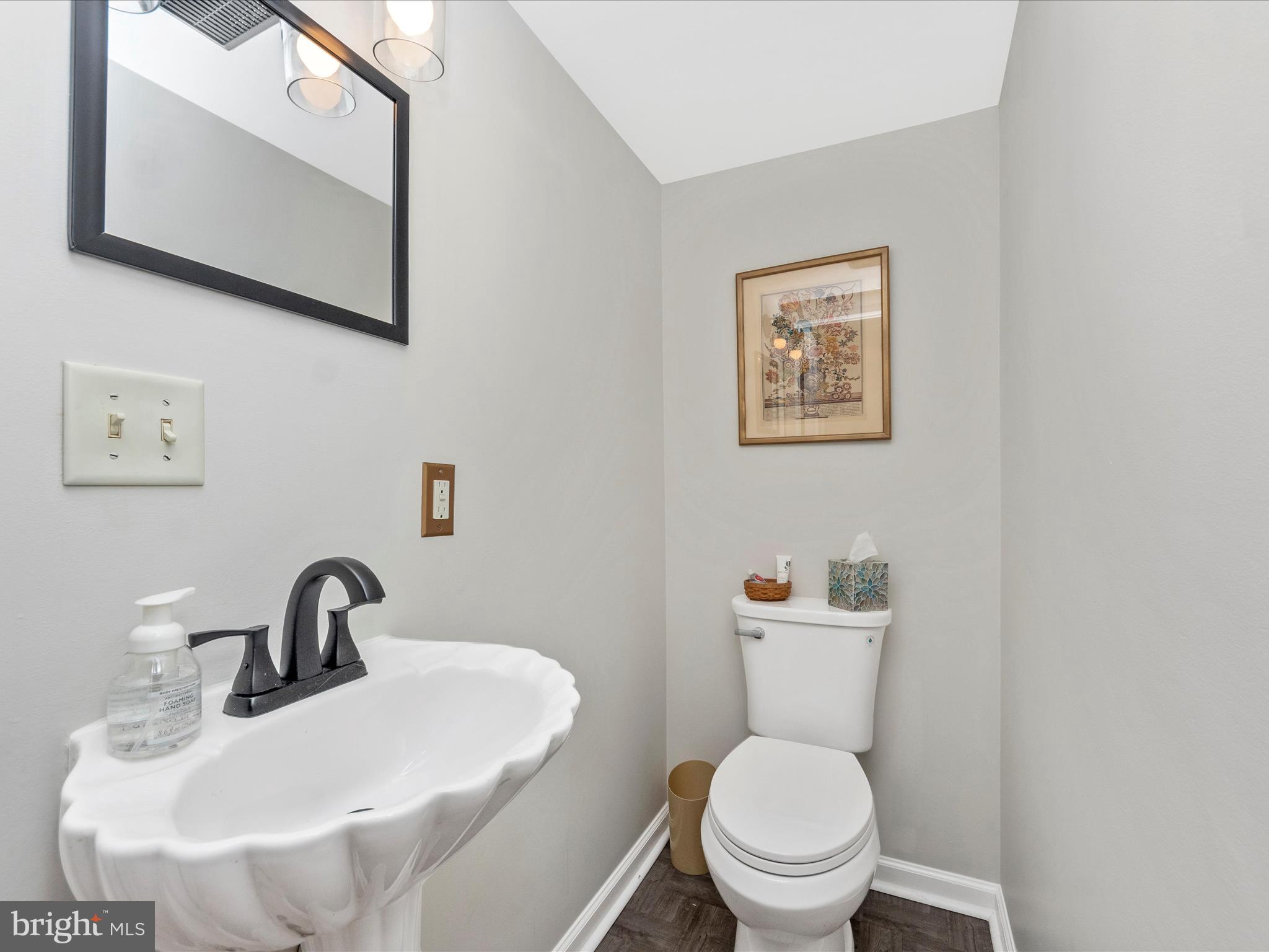 5610 Braxfield Road Halethorpe, MD 21227 - Photo 11 of 32 a bathroom with a toilet sink and mirror