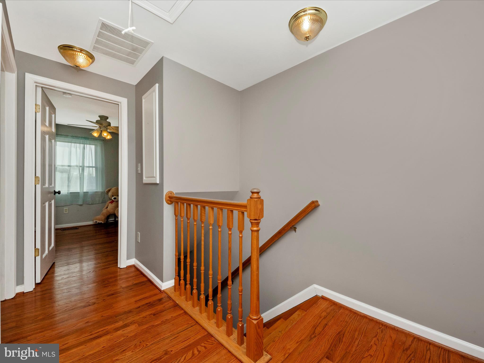 5610 Braxfield Road Halethorpe, MD 21227 - Photo 12 of 32 a view of a hallway with wooden floor and a bathroom