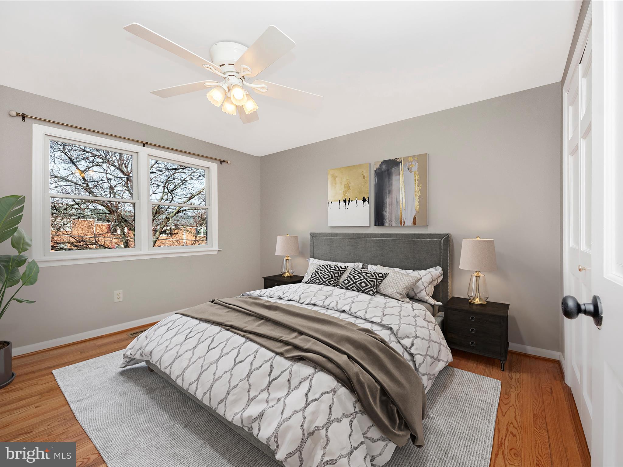 5610 Braxfield Road Halethorpe, MD 21227 - Photo 13 of 32 a bedroom with a large bed and a chandelier