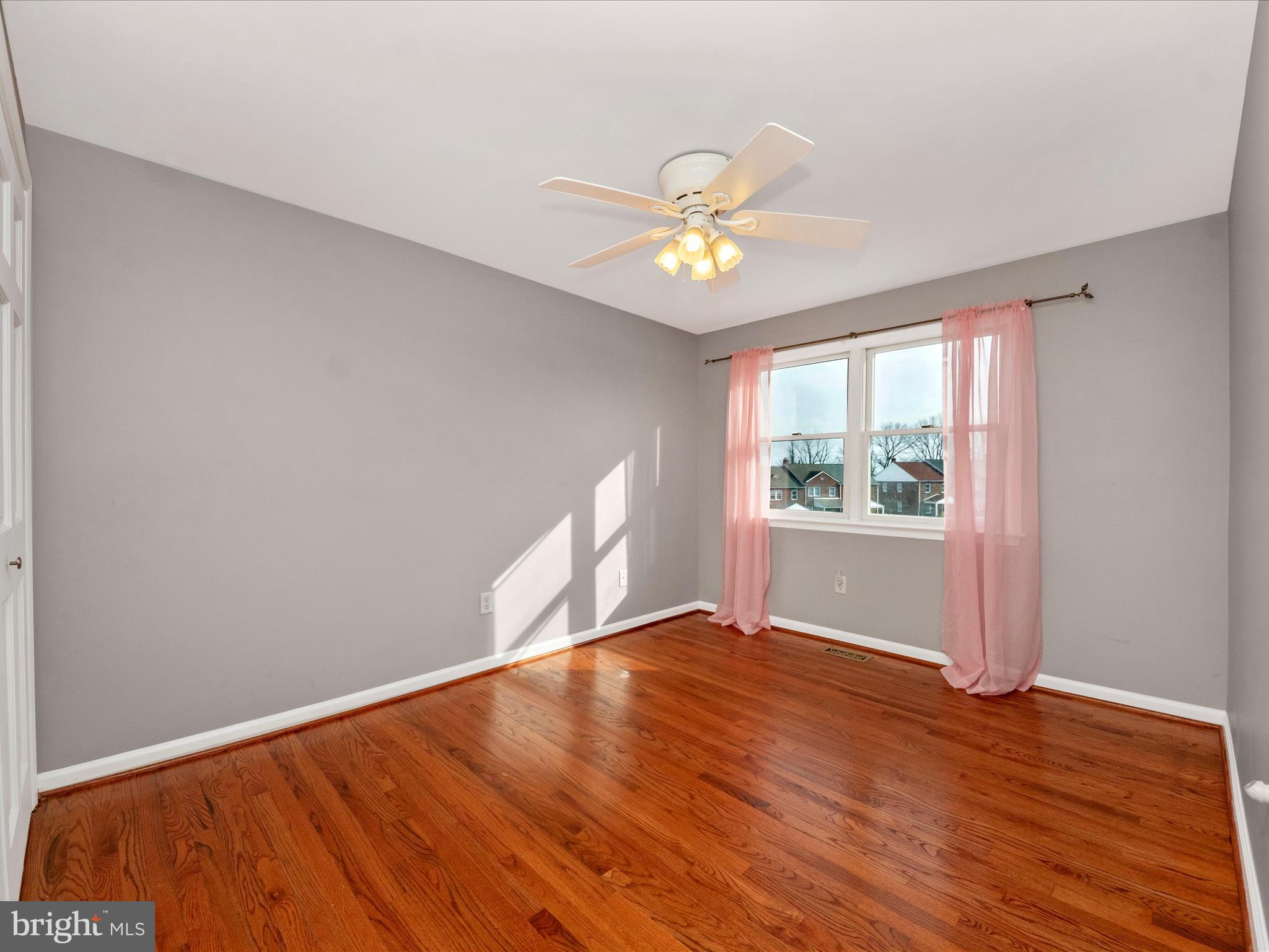 5610 Braxfield Road Halethorpe, MD 21227 - Photo 17 of 32 a view of an empty room with a window and wooden floor
