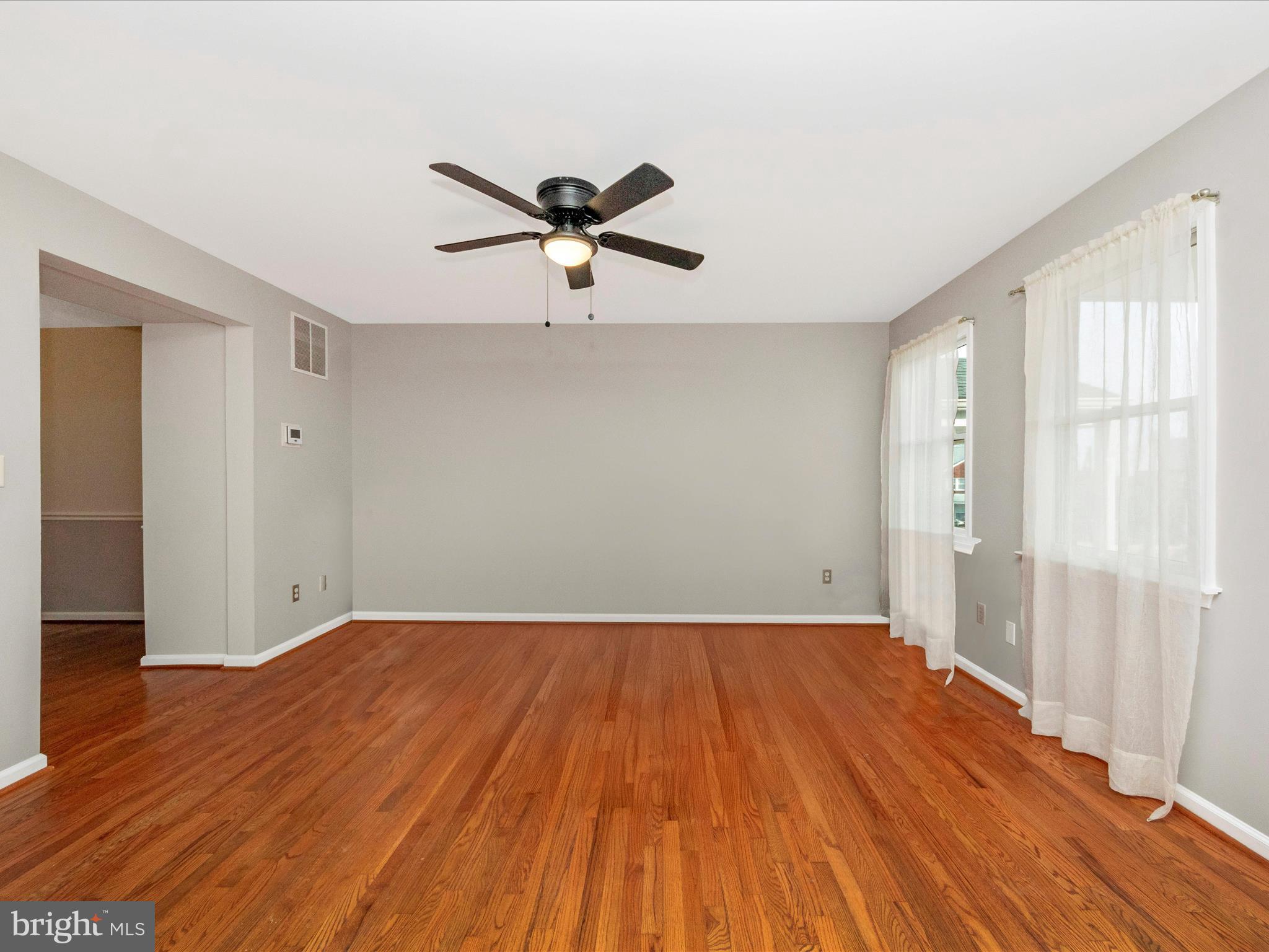 5610 Braxfield Road Halethorpe, MD 21227 - Photo 4 of 32 a view of empty room with wooden floor and fan