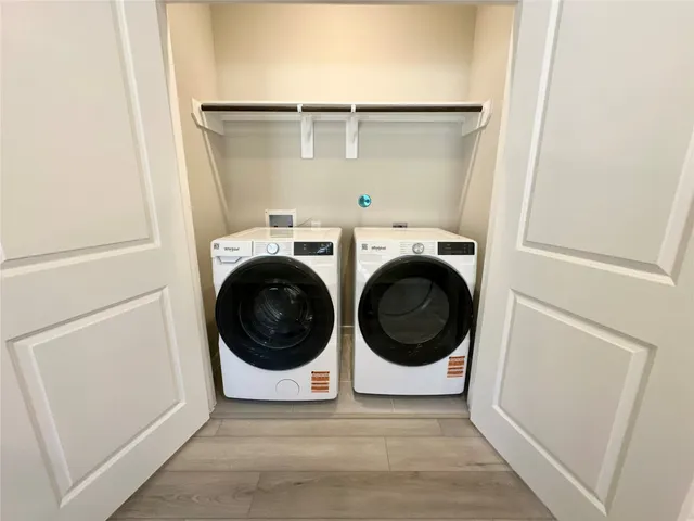 a view of a storage & utility room with dryer and washer