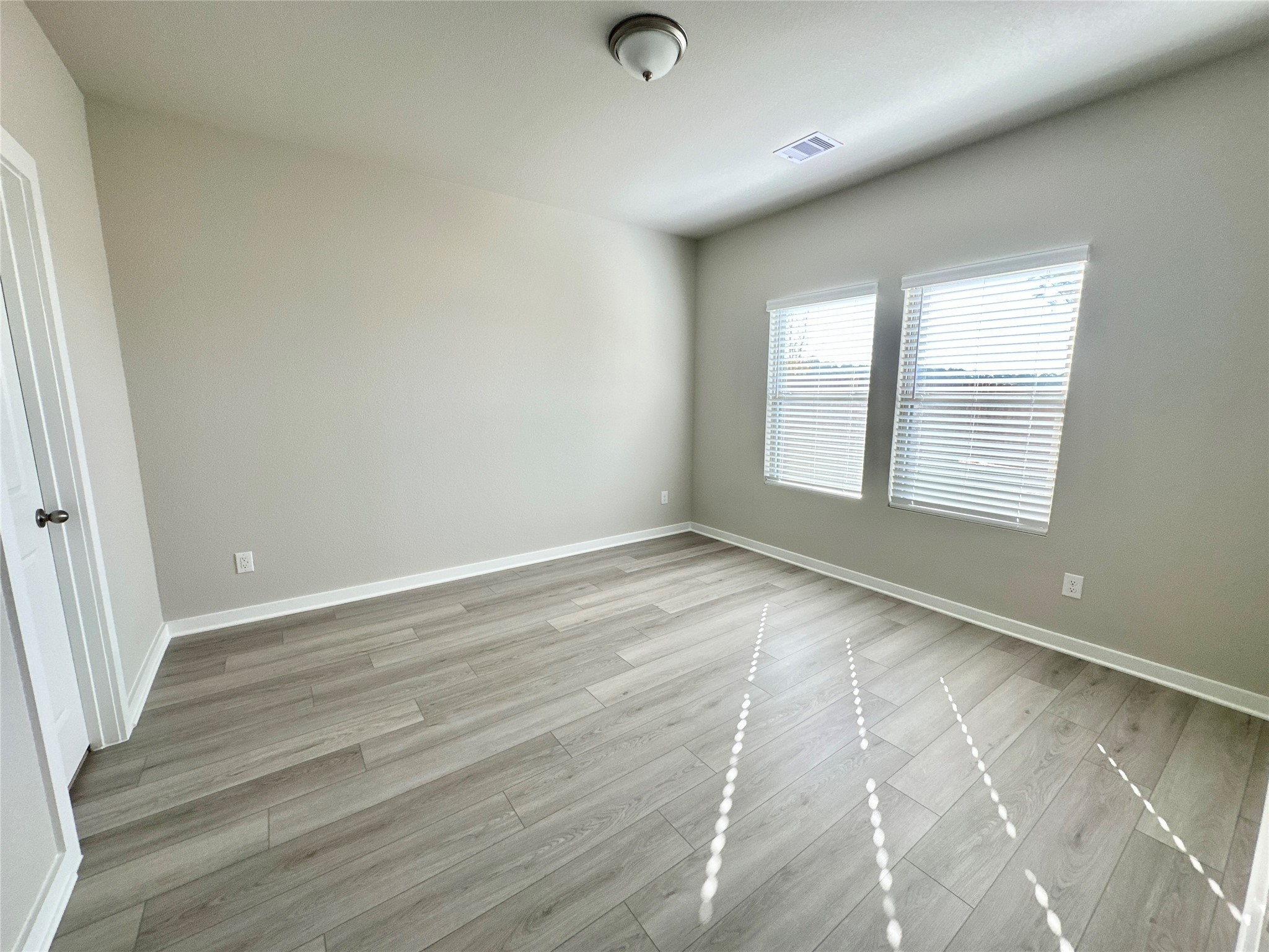 12194 Ridge Top Drive Conroe, TX 77304 - Photo 15 of 33 an empty room with wooden floor and windows