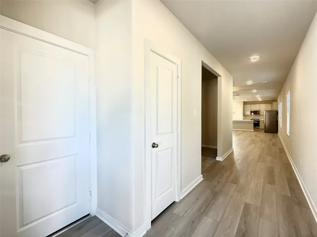 a view of a hallway with wooden floor
