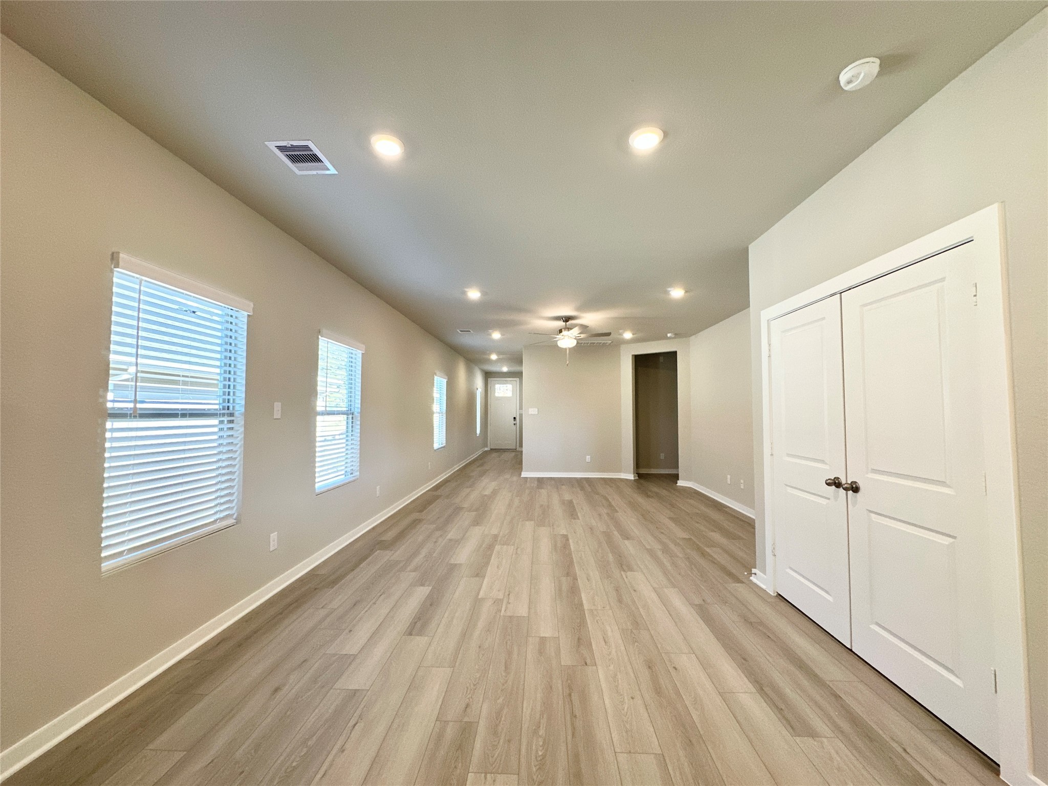 12194 Ridge Top Drive Conroe, TX 77304 - Photo 5 of 33 a view of an empty room with a window and wooden floor
