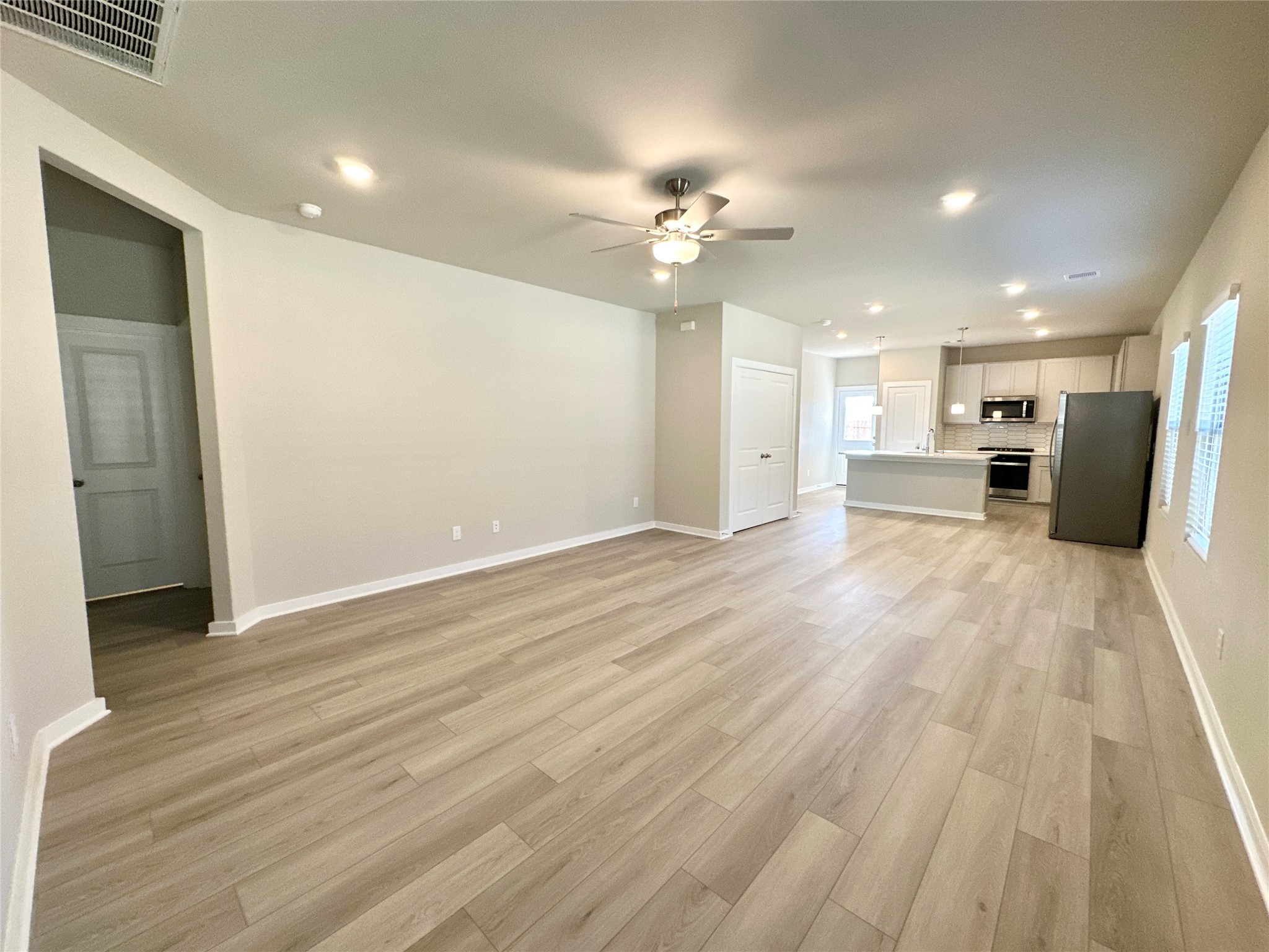 12194 Ridge Top Drive Conroe, TX 77304 - Photo 7 of 33 a view of a big room with wooden floor and a kitchen