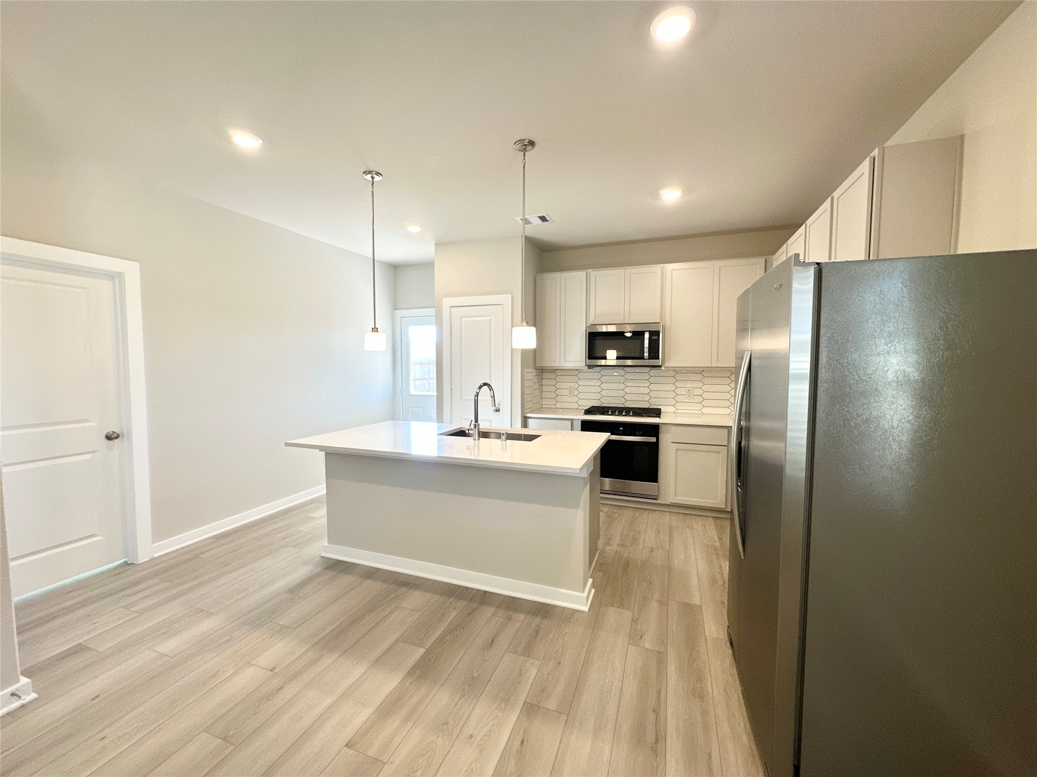 12194 Ridge Top Drive Conroe, TX 77304 - Photo 8 of 33 a large kitchen with kitchen island a sink stainless steel appliances and cabinets
