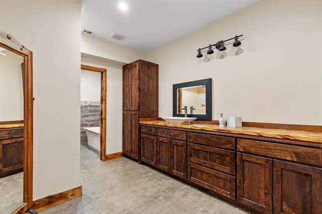 a bathroom with a bathtub and shower